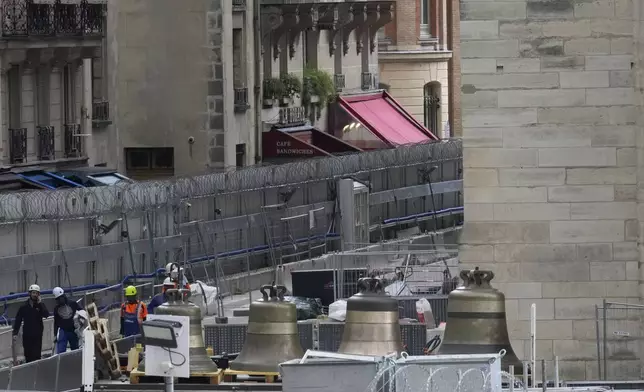 A truck carrying bells is parked outside Notre-Dame de Paris cathedral, in Paris, Thursday, Sept. 12, 2024. The Cathedral is getting its bells back, just in time for the medieval landmark's reopening following a devastating 2019 fire. (AP Photo/Michel Euler)