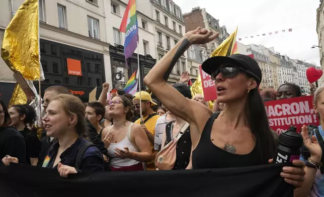 Demonstrators shout slogans during a protest, responding to a call from the far-left party who criticized as a power grab the president's appointment of a conservative new prime minister, Michel Barnier, in Paris, France, Saturday, Sept. 7, 2024. (AP Photo/Michel Euler)