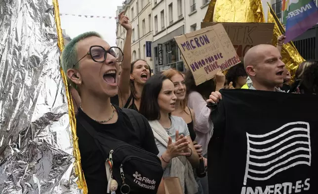 Demonstrators shout slogans during a protest, responding to a call from the far-left party who criticized as a power grab the president's appointment of a conservative new prime minister, Michel Barnier, in Paris, France, Saturday, Sept. 7, 2024. (AP Photo/Michel Euler)