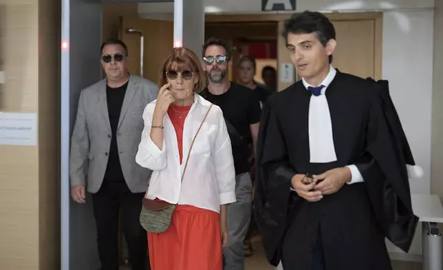 Gisele Pelicot, centre left, leaves the Avignon court house with her sons, David, left, Florian, center background and her lawyer Stephane Babonneau, right, in Avignon, southern France, Thursday, Sept. 5, 2024. A woman allegedly drugged by her ex-husband so that she could be raped by other men while she laid unconscious, is expected to testify before a panel of French judges. (AP Photo/Lewis Joly)