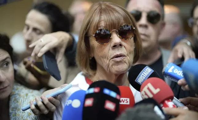 FILE - Gisele Pelicot speaks to media as she leaves the Avignon court house, southern France, Thursday, Sept. 5, 2024. (AP Photo/Lewis Joly, File)