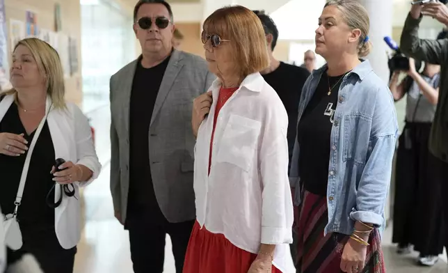 Gisele Pelicot, center, arrives in the Avignon court house, in Avignon, southern France, Thursday, Sept. 5, 2024. A woman allegedly drugged by her ex-husband so that she could be raped by other men while she laid unconscious, is expected to testify before a panel of French judges. (AP Photo/Lewis Joly)