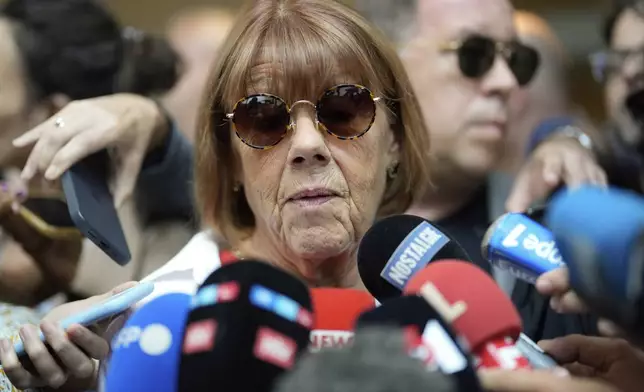 Gisele Pelicot speaks to media as she leaves the Avignon court house, southern France, Thursday, Sept. 5, 2024. A woman allegedly drugged by her ex-husband so that she could be raped by other men while she laid unconscious, is expected to testify before a panel of French judges. (AP Photo/Lewis Joly)