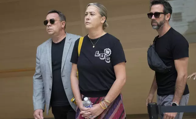 The sons of Gisele Pelicot, Florian, right, David, left, and her daughter Caroline Darian, center, arrive in the Avignon court house, southern France, Thursday, Sept. 5, 2024. (AP Photo/Lewis Joly)