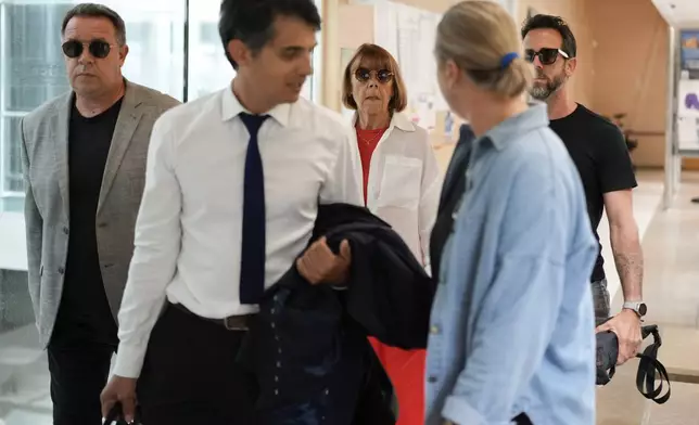 Gisele Pelicot, center, arrives in the Avignon court house, in Avignon, southern France, Thursday, Sept. 5, 2024. A woman allegedly drugged by her ex-husband so that she could be raped by other men while she laid unconscious, is expected to testify before a panel of French judges. (AP Photo/Lewis Joly)