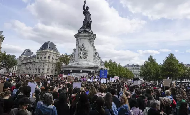 People take part in a gathering at Place de la Rebublique in support of 71-year-old Gisele Pelicot who was allegedly drugged by her ex-husband and raped by dozens of men while unconscious, Saturday, Sept. 14, 2024 in Paris. (AP Photo/Michel Euler)