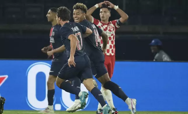 PSG players celebrate after a goal during the Champions League opening phase soccer match between Paris Saint-Germain and Girona at the Parc des Princes stadium in Paris, France, Wednesday, Sept. 18, 2024. (AP Photo/Christophe Ena)