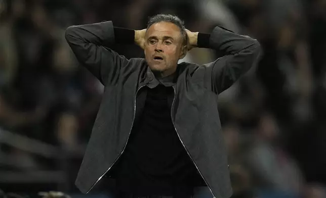 PSG's head coach Luis Enrique reacts during the Champions League opening phase soccer match between Paris Saint-Germain and Girona at the Parc des Princes stadium in Paris, France, Wednesday, Sept. 18, 2024. (AP Photo/Christophe Ena)