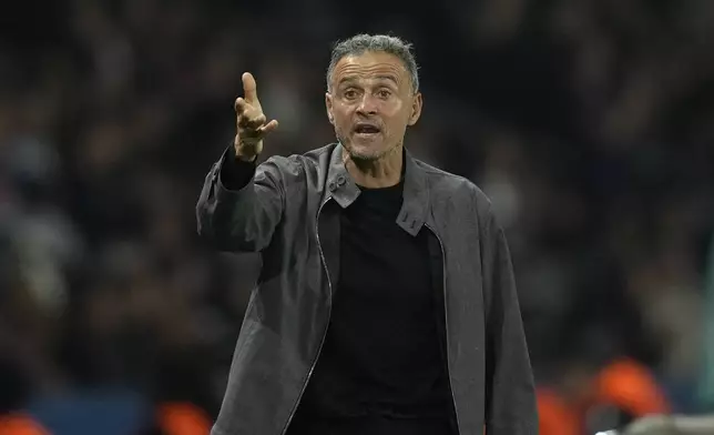 PSG's head coach Luis Enrique gives instructions during the Champions League opening phase soccer match between Paris Saint-Germain and Girona at the Parc des Princes stadium in Paris, France, Wednesday, Sept. 18, 2024. (AP Photo/Christophe Ena)