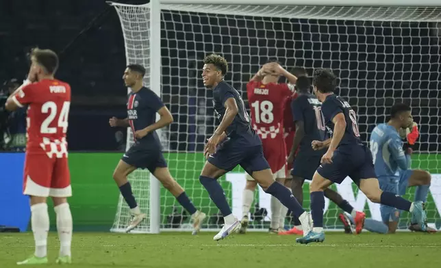 PSG players celebrate after a goal during the Champions League opening phase soccer match between Paris Saint-Germain and Girona at the Parc des Princes stadium in Paris, France, Wednesday, Sept. 18, 2024. (AP Photo/Christophe Ena)