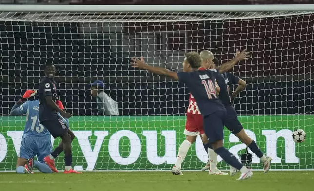 PSG players celebrate after a goal during the Champions League opening phase soccer match between Paris Saint-Germain and Girona at the Parc des Princes stadium in Paris, France, Wednesday, Sept. 18, 2024. (AP Photo/Christophe Ena)