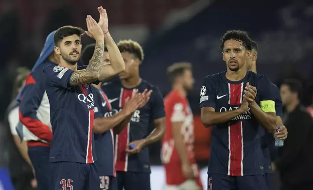 PSG players leave the pitch after they won the Champions League opening phase soccer match between Paris Saint-Germain and Girona at the Parc des Princes stadium in Paris, France, Wednesday, Sept. 18, 2024. (AP Photo/Christophe Ena)