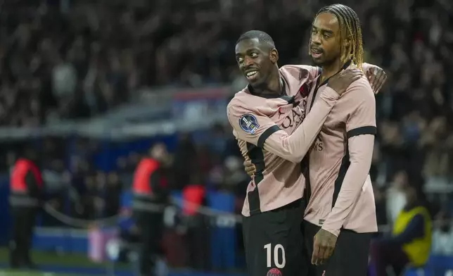 PSG's Bradley Barcola, right, celebrates with PSG's Ousmane Dembele after scoring his side's opening goal during the French League One soccer match between Paris Saint-Germain and Rennes at the Parc des Princes in Paris, Friday, Sept. 27, 2024. (AP Photo/Thibault Camus)