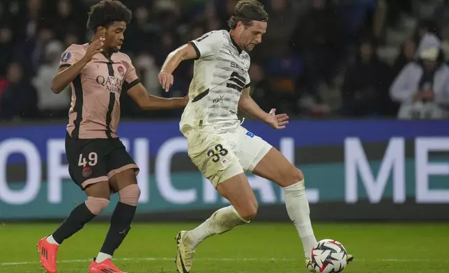 Rennes' Hans Hateboer, right, duels for the ball with PSG's Ibrahim Mbaye during the French League One soccer match between Paris Saint-Germain and Rennes at the Parc des Princes in Paris, Friday, Sept. 27, 2024. (AP Photo/Thibault Camus)