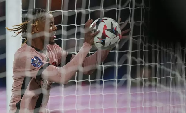 PSG's Bradley Barcola celebrates after scoring his side's third goal during the French League One soccer match between Paris Saint-Germain and Rennes at the Parc des Princes in Paris, Friday, Sept. 27, 2024. (AP Photo/Thibault Camus)