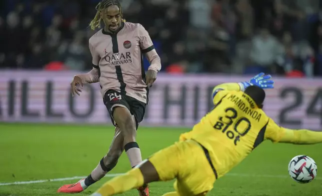 PSG's Bradley Barcola, left, scores his side's third goal during the French League One soccer match between Paris Saint-Germain and Rennes at the Parc des Princes in Paris, Friday, Sept. 27, 2024. (AP Photo/Thibault Camus)