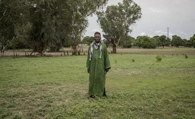 Ansumana Sanneh, whose son migrated to Russia, poses for a portrait on his farm in Kwinella village, Gambia, on July 27, 2024. (AP Photo/Annika Hammerschlag)