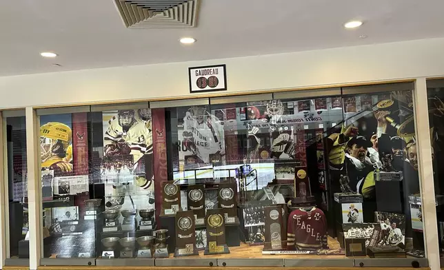 A sign hangs above the trophy case at Boston College's Conte Forum mourning the deaths of former Eagles hockey players Johnny and Matthew Gaudreau in Boston, Wednesday, Sept. 4, 2024. (AP Photo/Jimmy Golen)