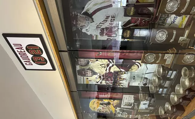 A sign hangs above the trophy case at Boston College's Conte Forum mourning the deaths of former Eagles hockey players Johnny and Matthew Gaudreau in Boston, Wednesday, Sept. 4, 2024. (AP Photo/Jimmy Golen)