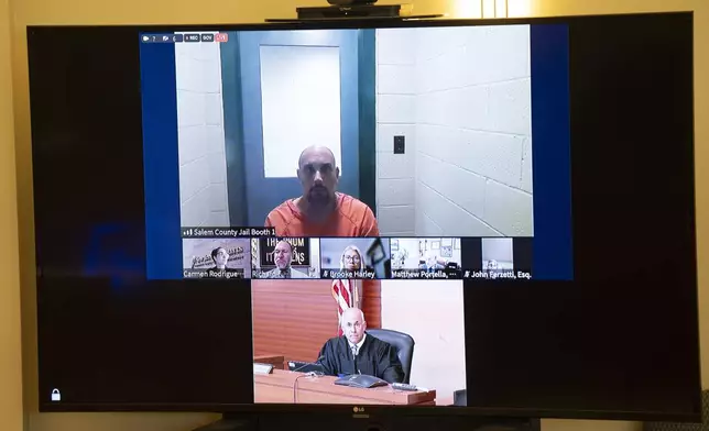 Sean M. Higgins, top, the suspected drunken driver charged with killing NHL hockey player Johnny Gaudreau and his brother Matthew as they bicycled on a rural road, appears before Judge Michael Silvanio, for his hearing via video from jail, Thursday Sept. 5, 2024, in Woodbury, N.J. (AP Photo/Matt Rourke)