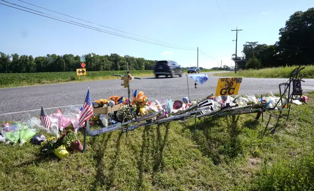 Vehicles move past a makeshift memorial for NHL hockey player Johnny Gaudreau and his brother Matthew who were killed by a suspected drunken driver as they bicycled on a rural road, Sept. 5, 2024, in Oldmans Township , N.J., Thursday. (AP Photo/Matt Rourke)