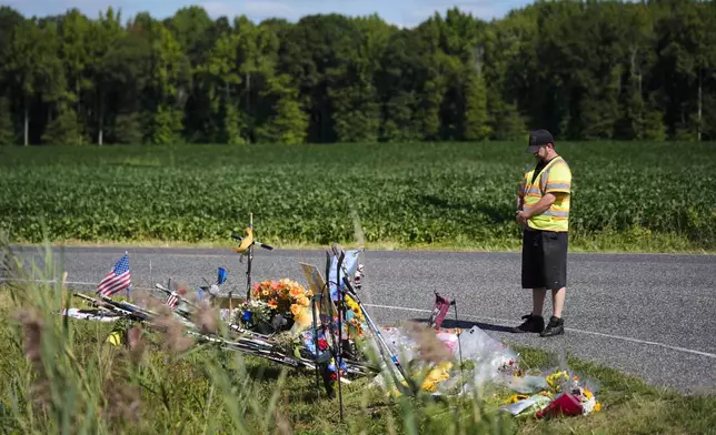 Wade Ingraham pays his respects at a makeshift memorial for NHL hockey player Johnny Gaudreau and his brother Matthew who were killed by a suspected drunken driver as they bicycled on a rural road, Sept. 5, 2024, in Oldmans Township , N.J., Thursday. (AP Photo/Matt Rourke)