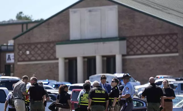 Police gather outside Apalachee High School after a shooting at the school Wednesday, Sept. 4, 2024, in Winder, Ga. (AP Photo/Mike Stewart)