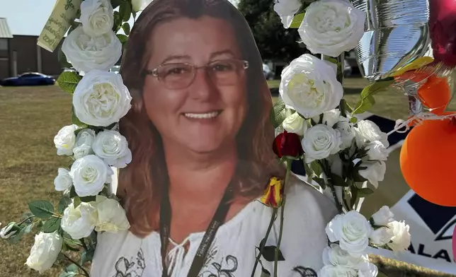 A poster with an image of shooting victim Cristina Irimie is displayed at a memorial outside Apalachee High School, Tuesday, Sept. 10, 2024, in Winder, Ga. (AP Photo/Charlotte Kramon)