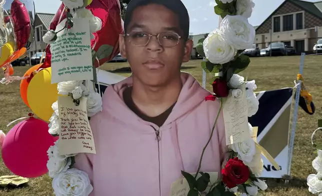 A poster with an image of shooting victim Mason Schermerhorn is displayed at a memorial outside Apalachee High School, Tuesday, Sept. 10, 2024, in Winder, Ga. (AP Photo/Charlotte Kramon)