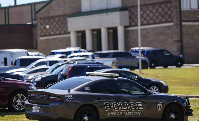 Police vehicles are seen outside Apalachee High School after a shooting there caused an unknown number of injuries and a suspect was arrested Wednesday, Sept. 4, 2024, in Winder, Ga. (AP Photo/Mike Stewart)