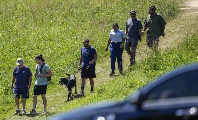 People leave Apalachee High School after a shooting at the school Wednesday, Sept. 4, 2024, in Winder, Ga. (AP Photo/Mike Stewart)