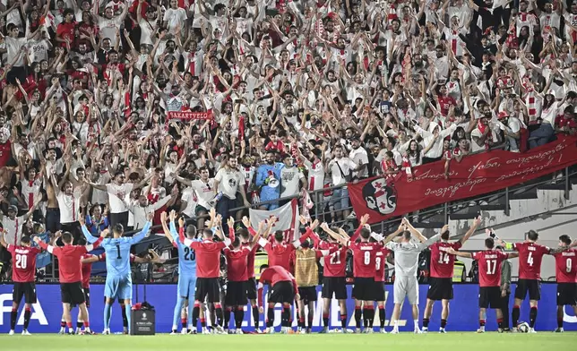 Georgia's players celebrate their 4-1 victory in the UEFA Nations League soccer match between Georgia and Czech Republic at the Mikheil Meskhi stadium in Tbilisi, Georgia, Saturday, Sept. 7, 2024. (AP Photo/Tamuna Kulumbegashvili)