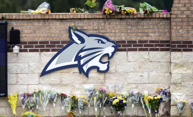 Flowers are displayed at a memorial outside Apalachee High School, Friday, Sept. 6, 2024, in Winder, Ga., following a shooting at the school earlier in the week. (Arvin Temkar/Atlanta Journal-Constitution via AP)