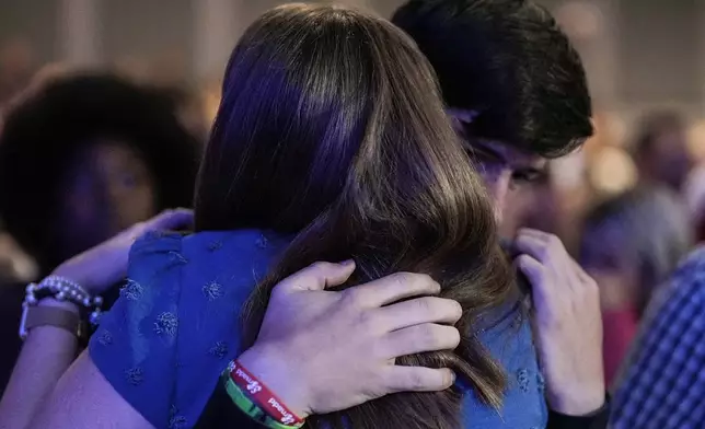 An Apalachee High School student is embraced during a Sunday service at Bethlehem Church, Sunday, Sept. 8, 2024, in Bethlehem, Ga. Grief, pain, hope and faith permeated church services in an Atlanta area community coping with the nation’s latest deadly school shooting. (AP Photo/Mike Stewart)