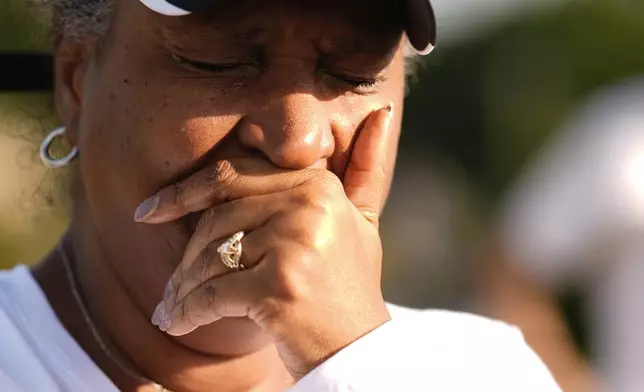 Chimain Douglas, of Grayson, Ga., cries near Apalachee High School as she mourners for the slain students and teachers on Thursday, Sept. 5, 2024, in Winder, Ga. (AP Photo/Brynn Anderson)