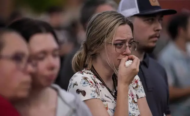 Mourners pray during a candlelight vigil for the slain students and teachers at Apalachee High School, Wednesday, Sept. 4, 2024, in Winder, Ga. (AP Photo/Mike Stewart)