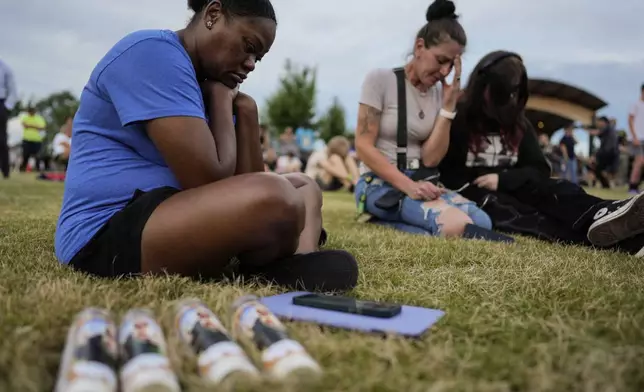 Mourners pray during a candlelight vigil for the slain students and teachers at Apalachee High School, Wednesday, Sept. 4, 2024, in Winder, Ga. (AP Photo/Mike Stewart)