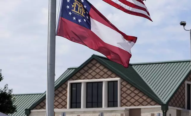 The American and state of Georgia flags fly half-staff after a shooting Wednesday at Apalachee High School, Thursday, Sept. 5, 2024, in Winder, Ga. (AP Photo/Mike Stewart)