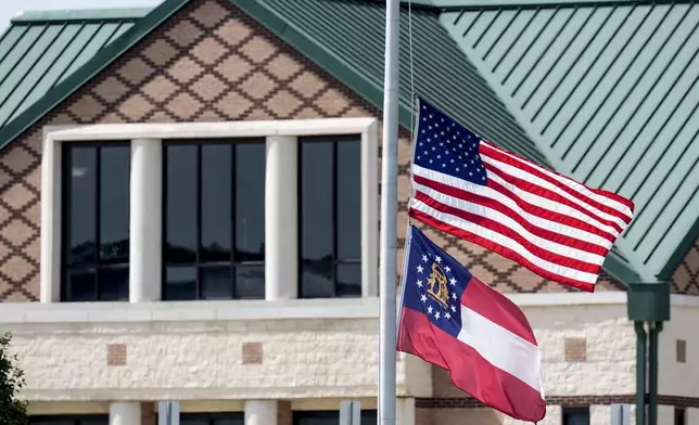 The American and state of Georgia flags fly half-staff after a shooting Wednesday at Apalachee High School, Thursday, Sept. 5, 2024, in Winder, Ga. (AP Photo/Mike Stewart)