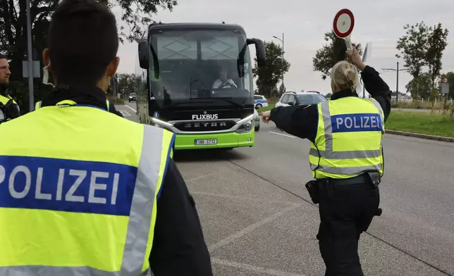 German police officers stop a bus at the border between Germany and France in Kehl, Germany, Monday, Sept. 16, 2024 as Germany controls all his borders from Monday on. (AP Photo/Jean-Francois Badias)