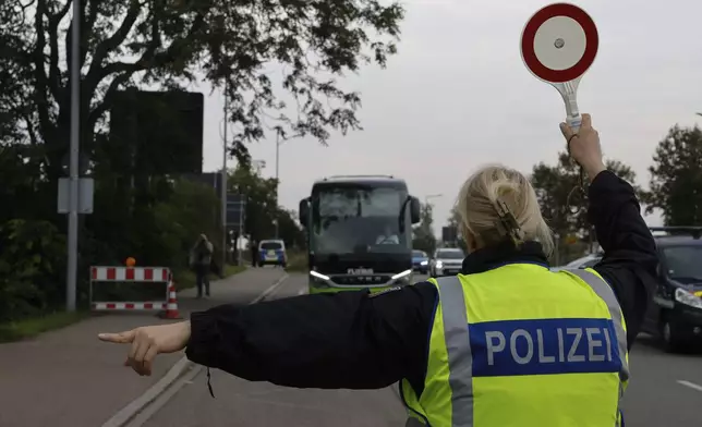 German police officers stop a bus at the border between Germany and France in Kehl, Germany, Monday, Sept. 16, 2024 as Germany controls all his borders from Monday on. (AP Photo/Jean-Francois Badias)