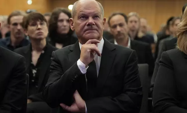 German Chancellor Olaf Scholz attends a commemoration service for the victims of a knife attack that killed three people last week, in Solingen, Germany, Sunday, Sept. 1, 2024. (AP Photo/Michael Probst, Pool)