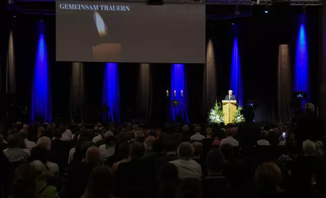 German President Frank-Walter Steinmeier speaks during a commemoration service for the victims of a knife attack that killed three people last week, in Solingen, Germany, Sunday, Sept. 1, 2024. Words in back ground reads: Mourning together. (AP Photo/Michael Probst, Pool)