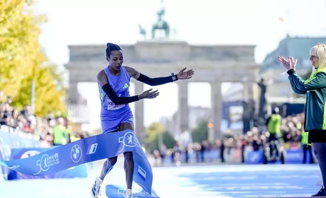 Tigist Ketema from Ethiopia celebrates as she crosses the finish line to win the women's division of the Berlin Marathon in Berlin, Germany, Sunday, Sept. 29, 2024. (AP Photo/Ebrahim Noroozi)