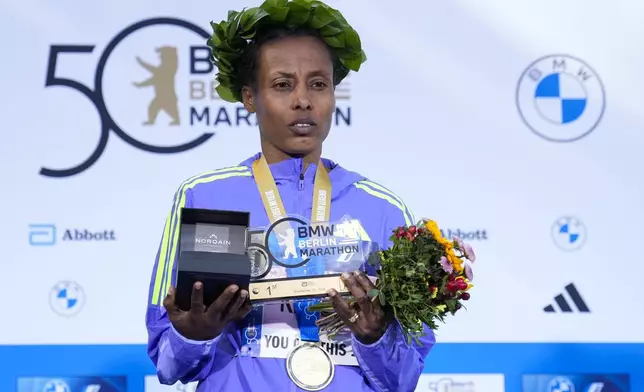 Tigist Ketema from Ethiopia attends the medals ceremony after she wins the women's division of the Berlin Marathon in Berlin, Germany, Sunday, Sept. 29, 2024. (AP Photo/Ebrahim Noroozi)