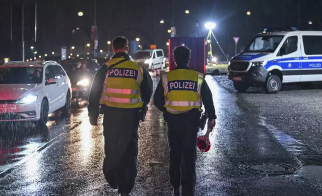 Two German Federal Police officers patrol at the border crossing to Poland in Frankfurt/Oder, Germany, Monday, Sept. 16, 2024. (Patrick Pleul/dpa via AP)