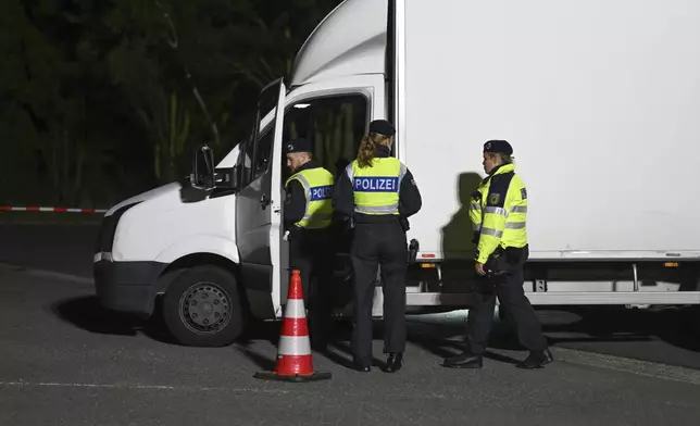 16 September 2024, Lower Saxony, Bunde: Police officers check a van at the Bunderneuland border crossing, in Bunde, Germany Monday, Sept. 16, 2024 as Germany has extended its existing border controls in the east and south of the country to the land border in the west. (Lars Penning/dpa via AP)