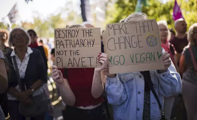 Protestors show posters as they take part in a Global Climate Strike protest of the Fridays For Future' movement near the chancellery in Berlin, Germany, Friday, Sept. 20, 2024. (AP Photo/Markus Schreiber)