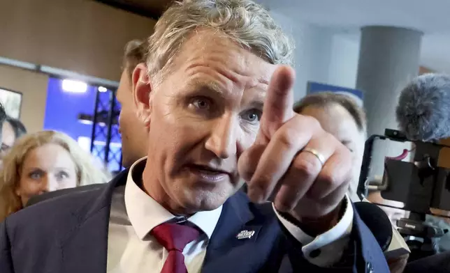 Bjoern Hoecke, top candidate in Thuringia of the far-right Alternative for Germany, gestures as he walks through the state parliament, in Erfurt, Germany, Sunday, Sept. 1, 2024. (Bodo Schackow/dpa via AP)