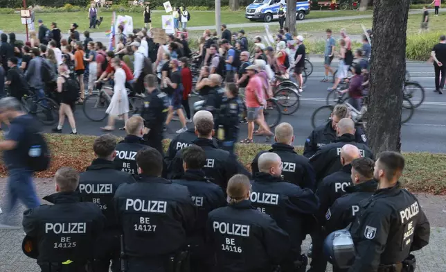 Police officers guard during a anti-fascist rally following the results of the state elections in Erfurt, Germany, Sunday, Sept. 1, 2024. (Michael Reichel/dpa via AP)